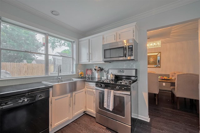 18206 Lake Bend Dr, Houston, TX 77084 - kitchen featuring appliances with stainless steel finishes, white cabinetry, a sink, ornamental molding, and dark wood finished floors