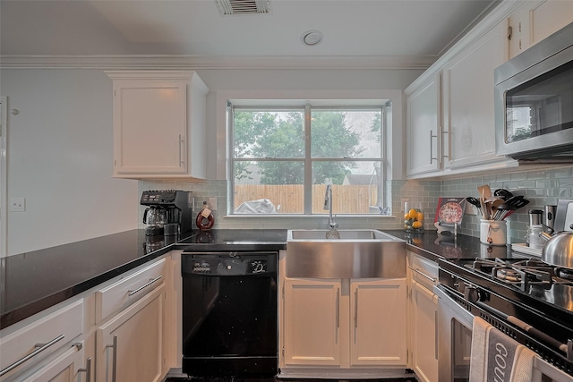 18206 Lake Bend Dr, Houston, TX 77084 - kitchen with appliances with stainless steel finishes, a sink, white cabinetry, decorative backsplash, and crown molding