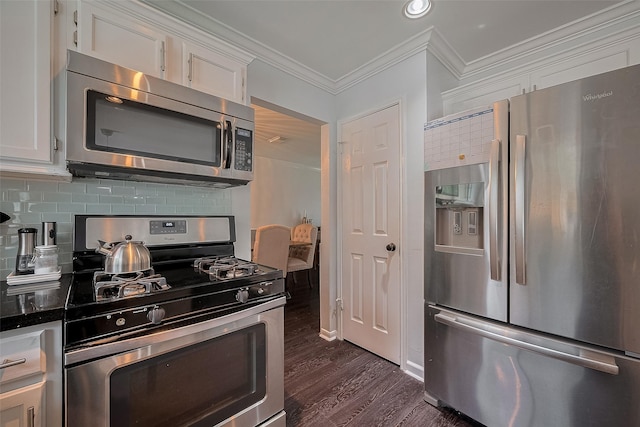 18206 Lake Bend Dr, Houston, TX 77084 - kitchen featuring appliances with stainless steel finishes, white cabinets, backsplash, dark wood finished floors, and crown molding
