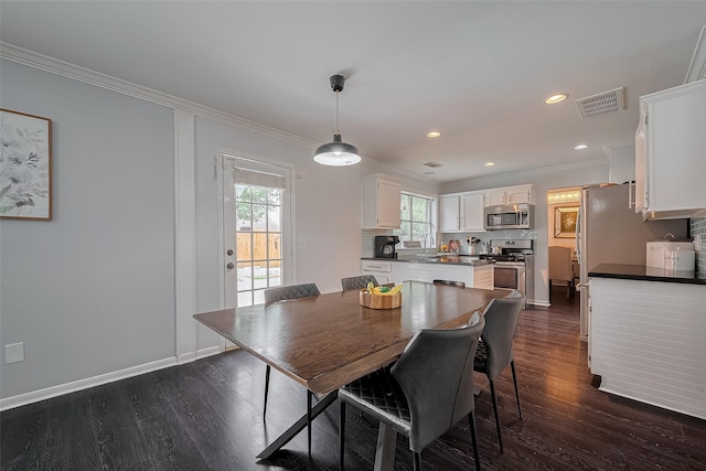 18206 Lake Bend Dr, Houston, TX 77084 - dining area featuring ornamental molding, dark wood-style flooring, baseboards, and recessed lighting