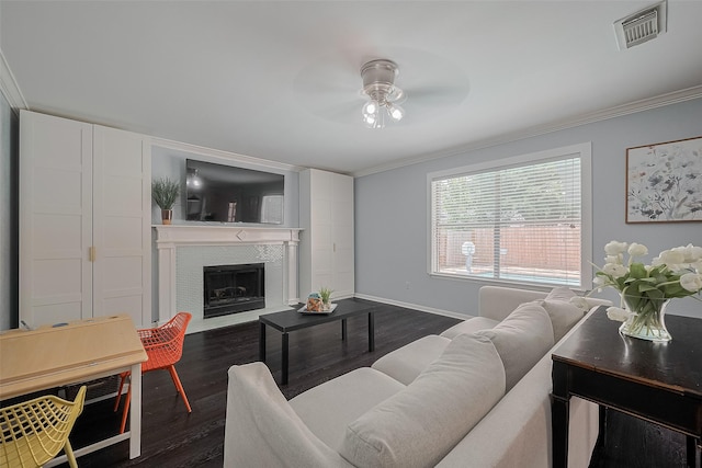 18206 Lake Bend Dr, Houston, TX 77084 - living room with ceiling fan, dark wood-style flooring, crown molding, baseboards, and a fireplace