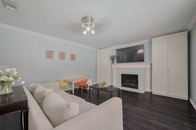 18206 Lake Bend Dr, Houston, TX 77084 - living area featuring a ceiling fan, crown molding, dark wood-type flooring, a tile fireplace, and baseboards