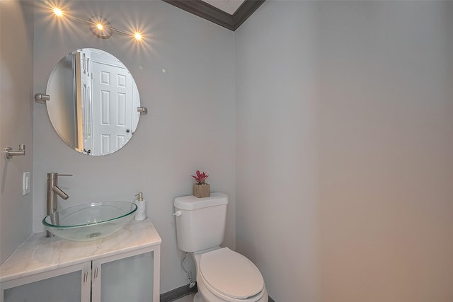 18206 Lake Bend Dr, Houston, TX 77084 - bathroom with toilet, vanity, and ornamental molding