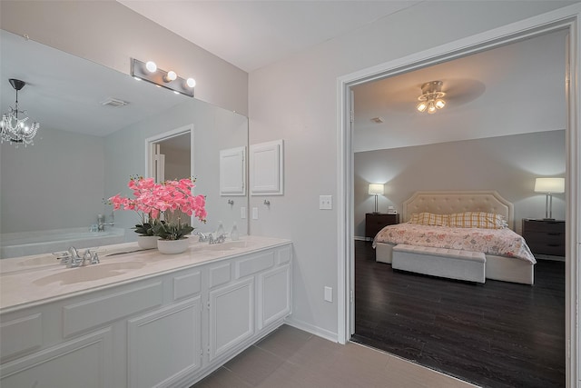 18206 Lake Bend Dr, Houston, TX 77084 - ensuite bathroom featuring double vanity, ceiling fan, baseboards, and a chandelier