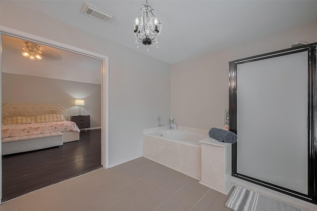 18206 Lake Bend Dr, Houston, TX 77084 - full bathroom featuring a garden tub, a stall shower, and baseboards