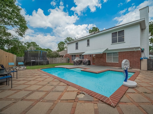 18206 Lake Bend Dr, Houston, TX 77084 - view of pool with a trampoline, a patio, and a fenced backyard