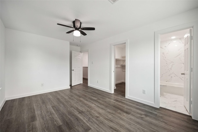 2310 Wavell St, Houston, TX 77088 - unfurnished bedroom with a walk in closet, baseboards, dark wood finished floors, a closet, and ensuite bathroom