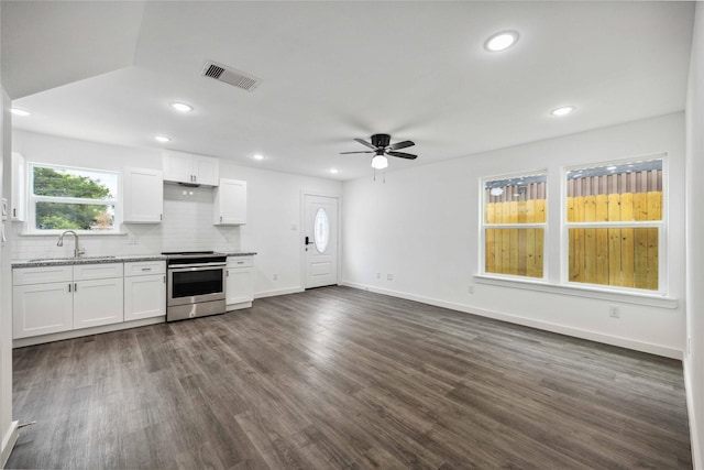 2310 Wavell St, Houston, TX 77088 - kitchen with stainless steel range with electric cooktop, a ceiling fan, a sink, white cabinets, and backsplash