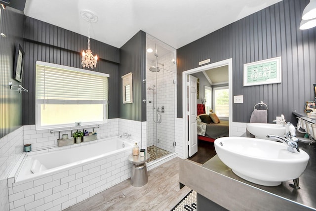 8910 Burleson Ct, Houston, TX 77064 - ensuite bathroom with a shower stall, wood finished floors, a garden tub, a sink, and a chandelier