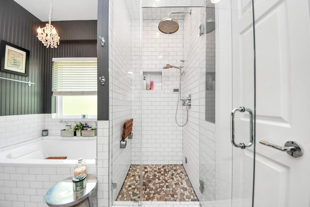 8910 Burleson Ct, Houston, TX 77064 - full bathroom with a chandelier, a stall shower, and a garden tub