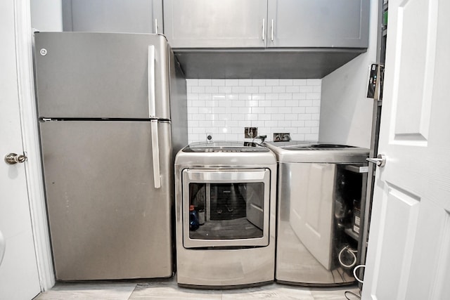 8910 Burleson Ct, Houston, TX 77064 - washroom featuring cabinet space and independent washer and dryer