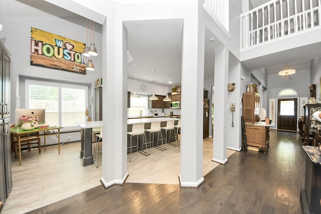 8910 Burleson Ct, Houston, TX 77064 - entrance foyer with a towering ceiling, wood finished floors, and baseboards