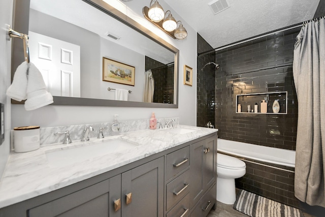 8910 Burleson Ct, Houston, TX 77064 - bathroom with tiled shower / bath, double vanity, and toilet