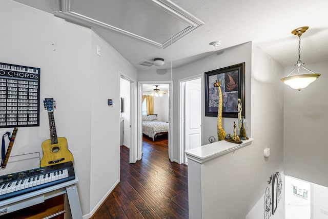 5306 Brookway Dr, Houston, TX 77084 - corridor with attic access, dark wood-style floors, and baseboards