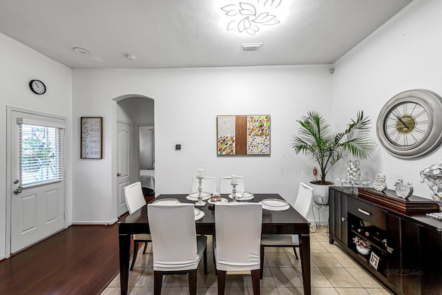 5306 Brookway Dr, Houston, TX 77084 - dining room featuring arched walkways, light tile patterned flooring, and baseboards