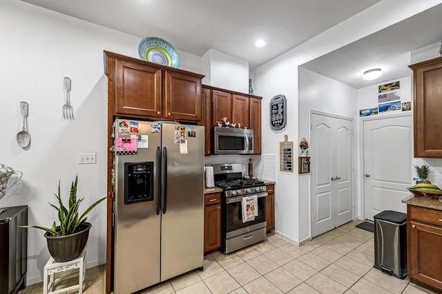 5306 Brookway Dr, Houston, TX 77084 - kitchen featuring stainless steel appliances, light tile patterned floors, and light stone countertops