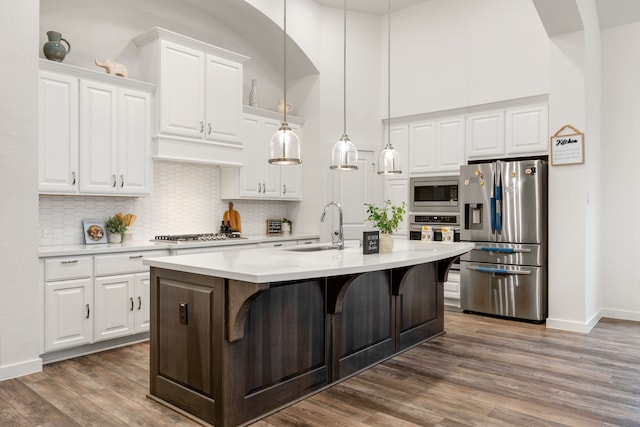 23603 Bottlebrush Terrace Trl, Katy, TX 77493 - kitchen with stainless steel appliances, a sink, a towering ceiling, backsplash, and light countertops