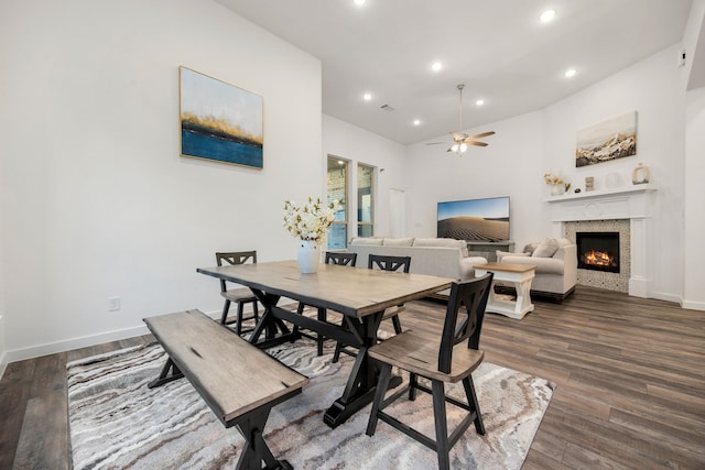 23603 Bottlebrush Terrace Trl, Katy, TX 77493 - dining space featuring a warm lit fireplace, ceiling fan, dark wood finished floors, baseboards, and recessed lighting