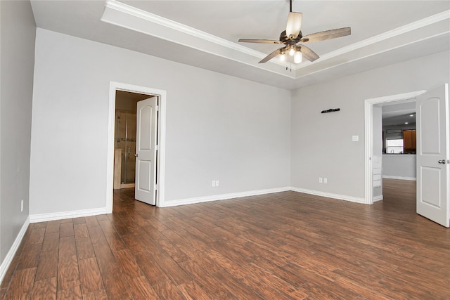 3014 Brahman Dr, Manvel, TX 77578 - spare room with a raised ceiling, baseboards, dark wood-style floors, a ceiling fan, and crown molding