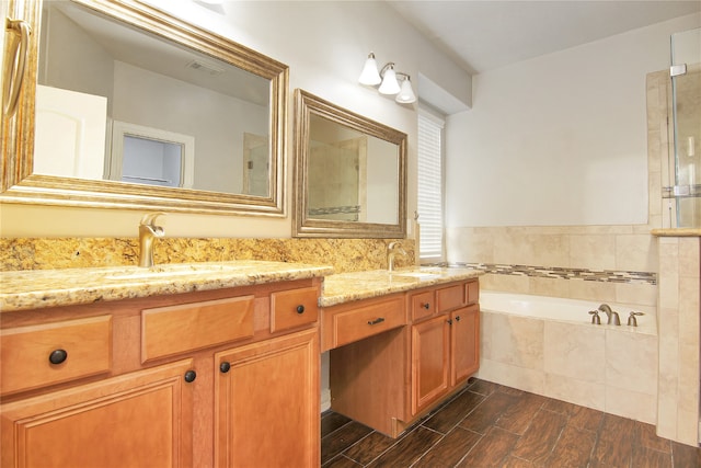 3014 Brahman Dr, Manvel, TX 77578 - full bath with double vanity, a bath, wood finished floors, and a tile shower
