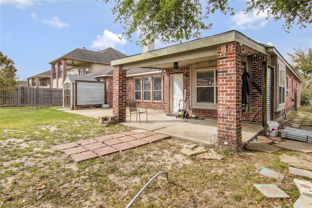 3014 Brahman Dr, Manvel, TX 77578 - back of house featuring brick siding, a patio area, and a chimney