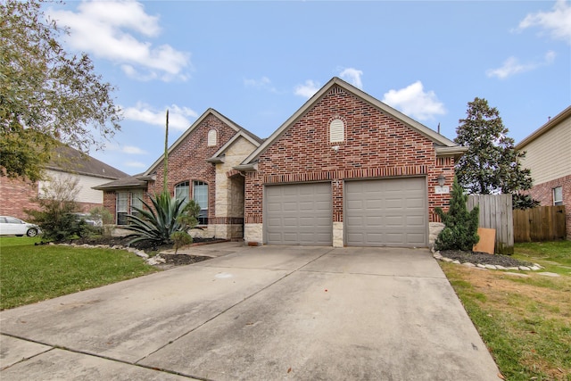 3014 Brahman Dr, Manvel, TX 77578 - traditional-style house with a garage, brick siding, concrete driveway, and stone siding