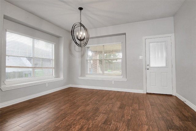 3014 Brahman Dr, Manvel, TX 77578 - unfurnished dining area featuring a chandelier, dark wood-style floors, and baseboards