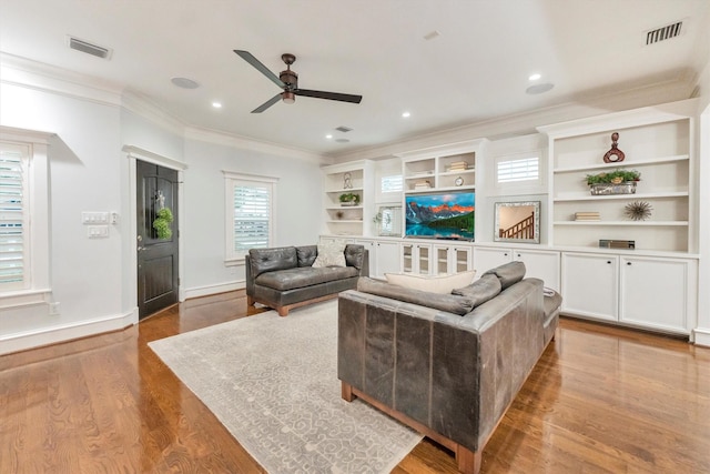 970 W 41st St, Houston, TX 77018 - living room featuring crown molding, a ceiling fan, wood finished floors, baseboards, and built in shelves