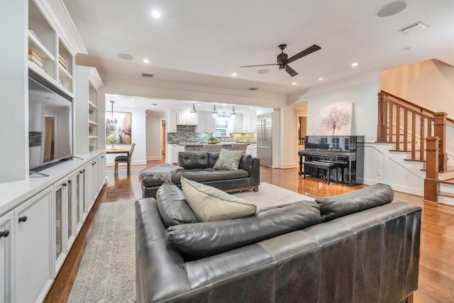 970 W 41st St, Houston, TX 77018 - living room featuring ceiling fan, stairway, ornamental molding, wood finished floors, and recessed lighting