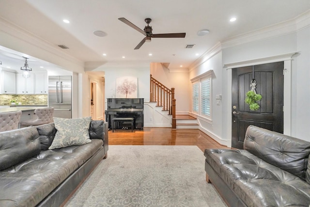 970 W 41st St, Houston, TX 77018 - living room featuring stairs, wood finished floors, a ceiling fan, crown molding, and recessed lighting