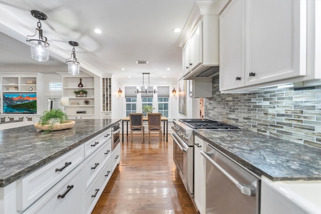 970 W 41st St, Houston, TX 77018 - kitchen with stainless steel appliances, white cabinetry, a chandelier, tasteful backsplash, and decorative light fixtures