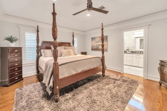 970 W 41st St, Houston, TX 77018 - bedroom with crown molding, light wood-type flooring, ensuite bath, a sink, and recessed lighting