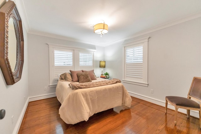 970 W 41st St, Houston, TX 77018 - bedroom featuring ornamental molding, wood finished floors, and baseboards