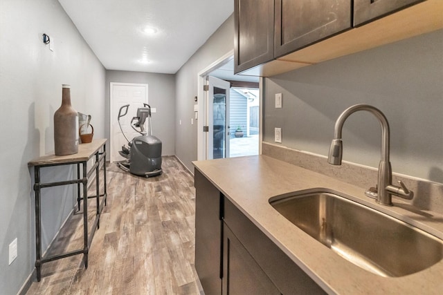 970 W 41st St, Houston, TX 77018 - kitchen with a sink, light wood-type flooring, dark brown cabinets, and light countertops