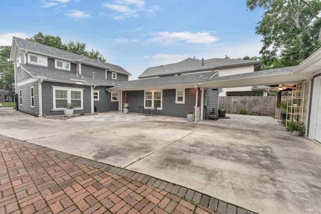 970 W 41st St, Houston, TX 77018 - rear view of property with roof with shingles and concrete driveway