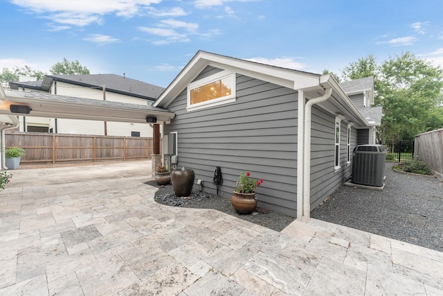 970 W 41st St, Houston, TX 77018 - view of side of home with cooling unit and a patio area