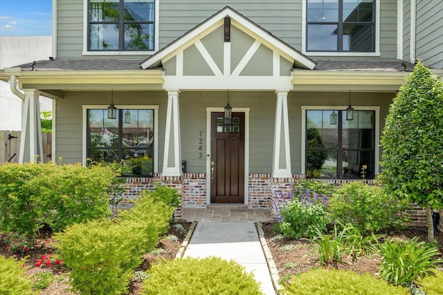 1243 Cheshire Ln, Houston, TX 77018 - entrance to property featuring covered porch, brick siding, and a shingled roof