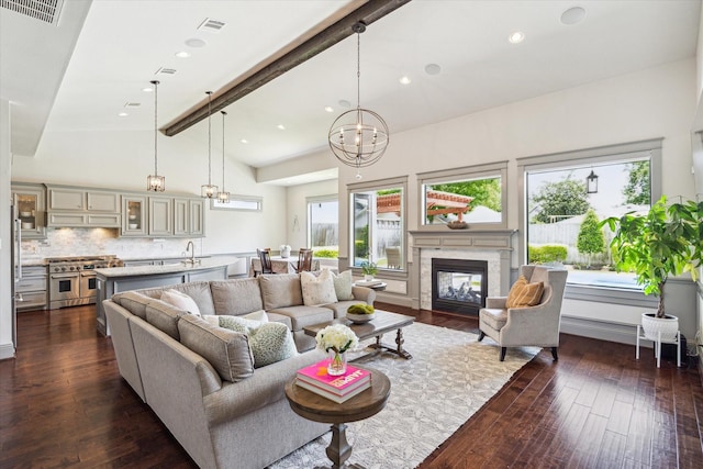 1243 Cheshire Ln, Houston, TX 77018 - living area featuring plenty of natural light, a chandelier, a premium fireplace, and dark wood-style flooring