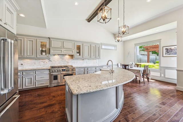 1243 Cheshire Ln, Houston, TX 77018 - kitchen with premium appliances, a sink, dark wood finished floors, gray cabinets, and tasteful backsplash