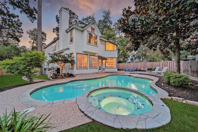 18 Heather Wisp Ct, Spring, TX 77381 - pool at dusk featuring a pool with connected hot tub