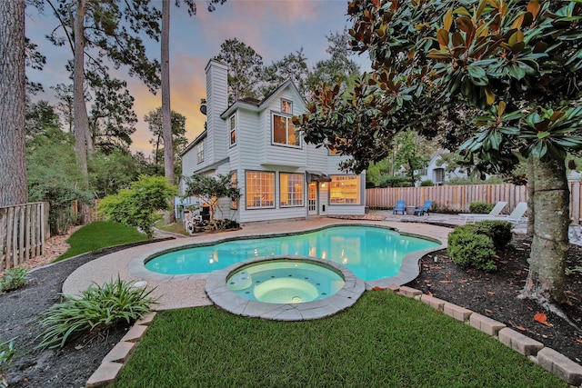18 Heather Wisp Ct, Spring, TX 77381 - pool at dusk with a pool with connected hot tub