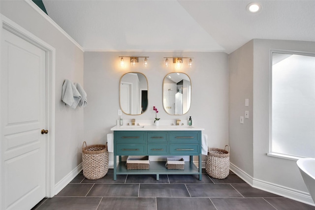 18 Heather Wisp Ct, Spring, TX 77381 - bathroom with double vanity, baseboards, tile patterned flooring, vaulted ceiling, and recessed lighting