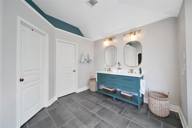 18 Heather Wisp Ct, Spring, TX 77381 - full bathroom with double vanity, vaulted ceiling, baseboards, and tile patterned floors