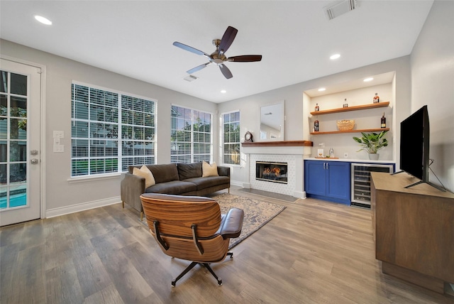 18 Heather Wisp Ct, Spring, TX 77381 - living area featuring wine cooler, light wood-type flooring, ceiling fan, baseboards, and recessed lighting