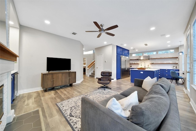 18 Heather Wisp Ct, Spring, TX 77381 - living room with ceiling fan, stairway, light wood-type flooring, recessed lighting, and baseboards