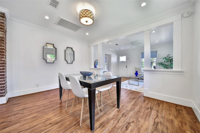 724 E 21st St, Houston, TX 77008 - dining area featuring ornate columns, baseboards, crown molding, ceiling fan, and light wood-style flooring