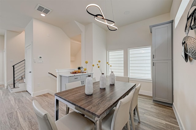 2905 Nagle St, Houston, TX 77004 - dining room with light wood-type flooring, stairway, baseboards, and recessed lighting