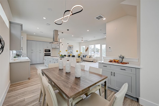 2905 Nagle St, Houston, TX 77004 - dining area with light wood-style flooring, recessed lighting, a ceiling fan, and baseboards