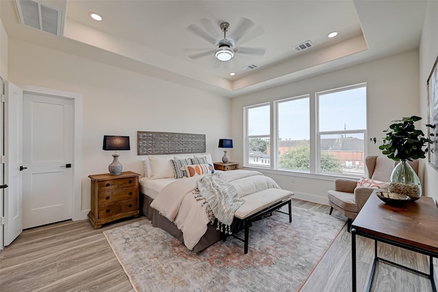2905 Nagle St, Houston, TX 77004 - bedroom with a tray ceiling, light wood-style flooring, baseboards, recessed lighting, and ceiling fan