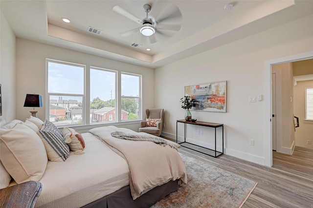 2905 Nagle St, Houston, TX 77004 - bedroom featuring wood finished floors, a raised ceiling, baseboards, recessed lighting, and a ceiling fan